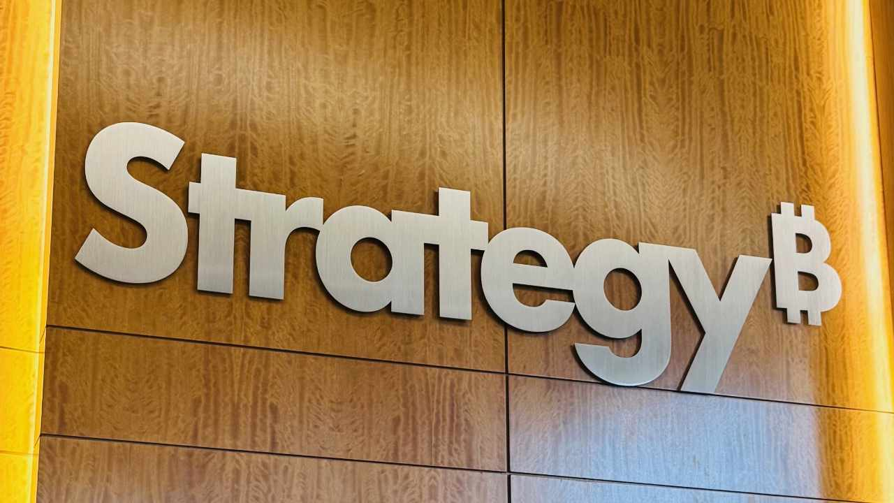 Strategy company logo on an office wall with a Bitcoin symbol.
